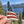 Idaho American Flag sticker held outdoors with a lake and evergreen trees in the background.
