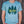 Load image into Gallery viewer, A unisex dusty blue heathered tee with our Woodsy design on the front

