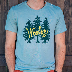 A unisex dusty blue heathered tee with our Woodsy design on the front